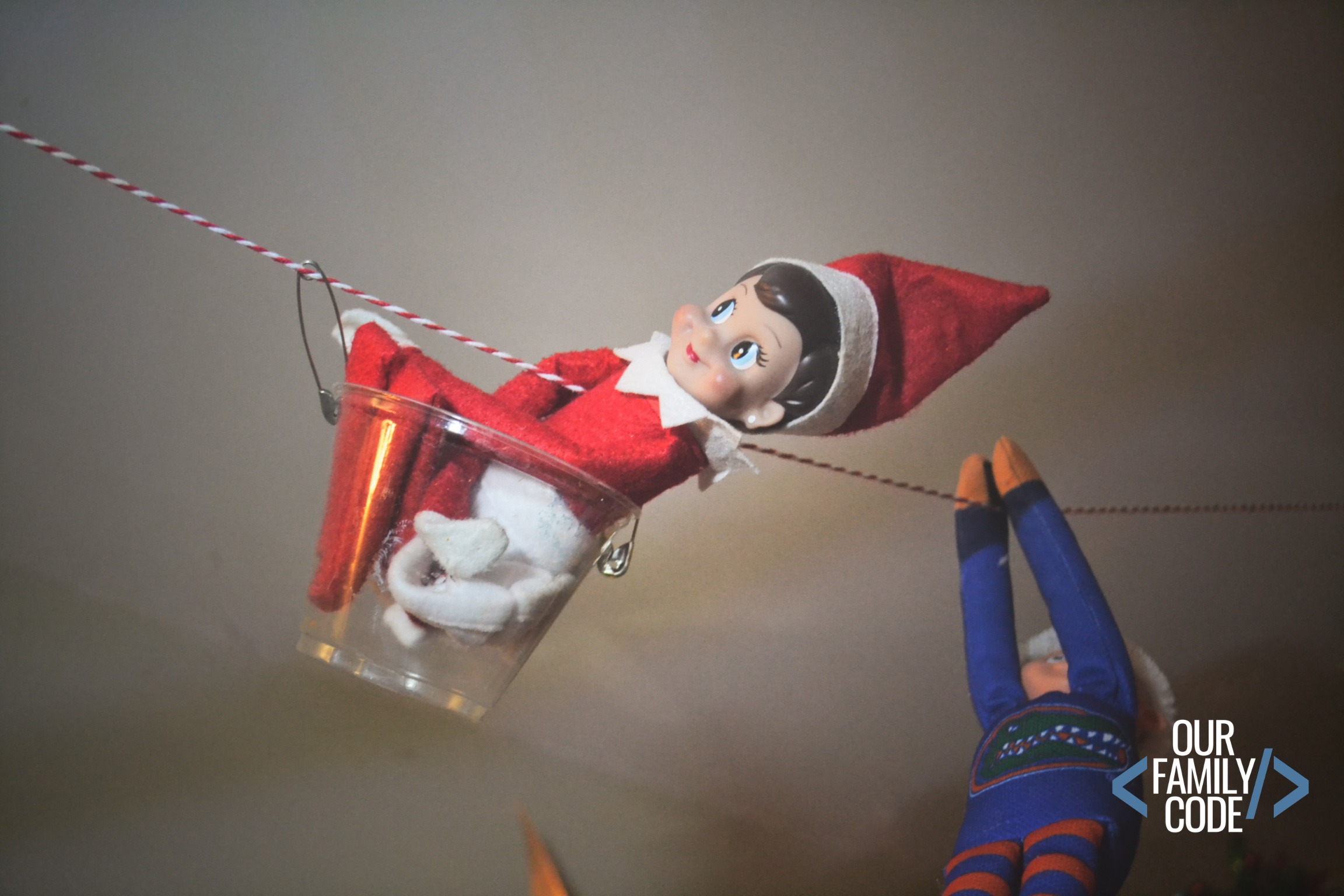 Elf on the Shelf Zipline wearing cape